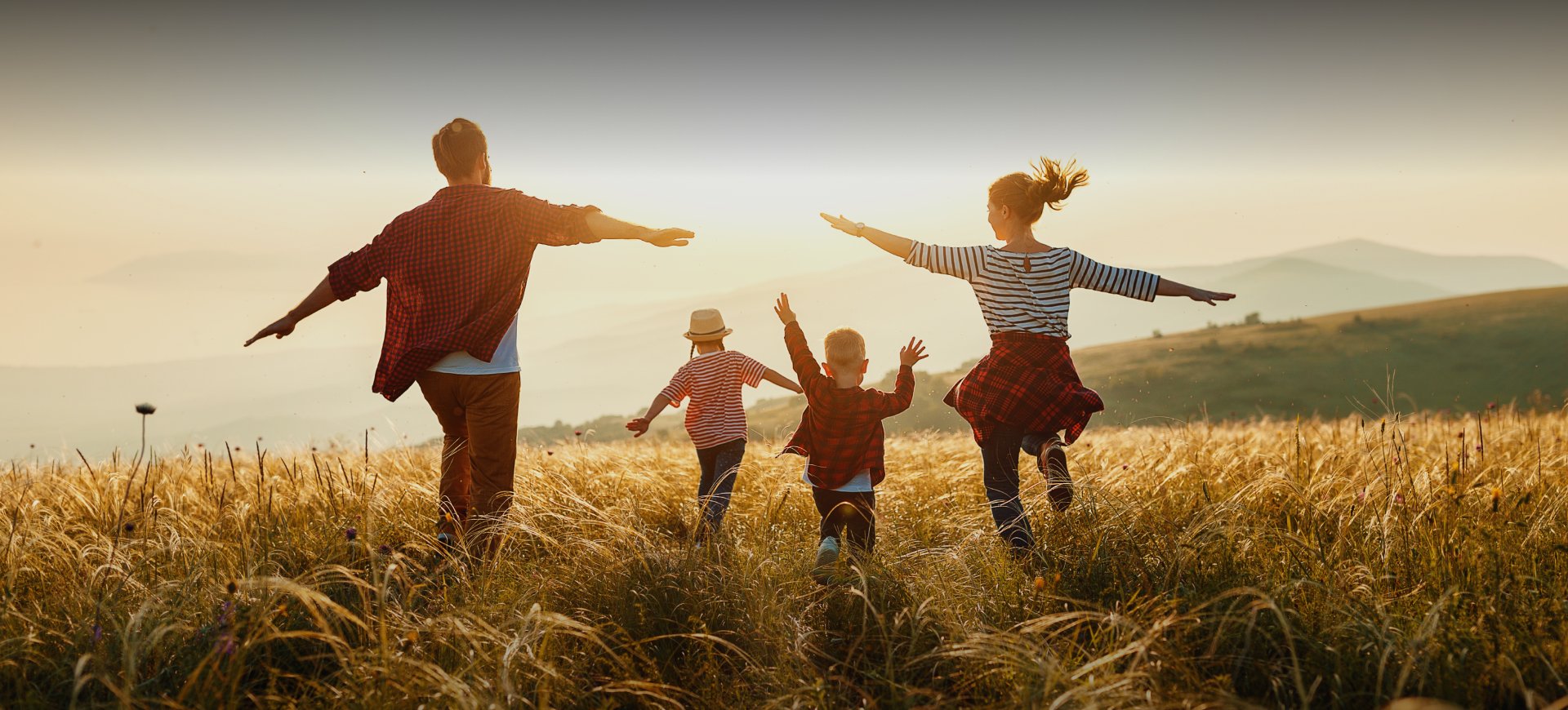 Family running through a field